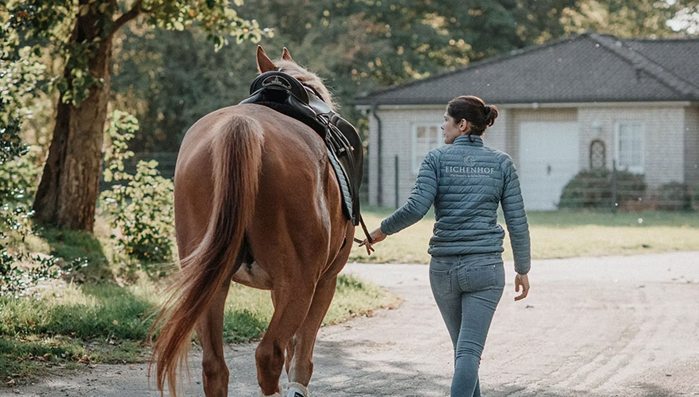 Nele Voß führt ein Pferd über den Hof